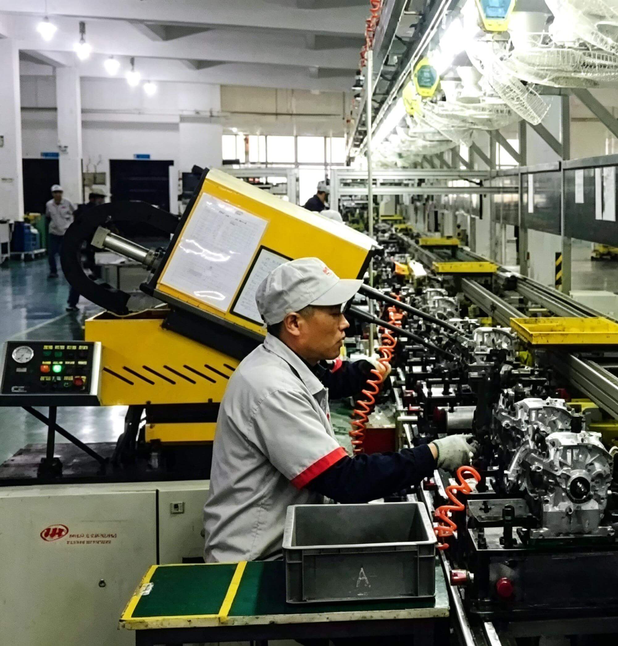 Workers performing quality inspection on outboard motors